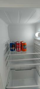two cans of soda in an open refrigerator at Apartamento Ana Maria in San Juan del Puerto