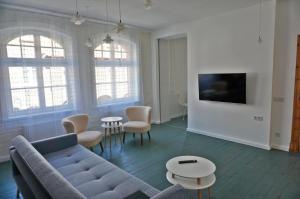 Televízia a/alebo spoločenská miestnosť v ubytovaní Muralowy apartament Katowice Nikiszowiec