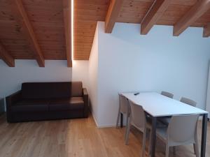 a living room with a table and a couch at Superior Beach Aparthotel in Lido di Jesolo