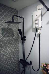 a shower in a bathroom with a hair dryer at Cebu Backpackers Hostel in Cebu City