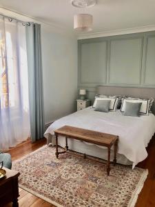 a bedroom with a large bed and a rug at Maison du 7 in Saint-Ouen-en-Belin