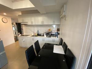 a kitchen with a table and chairs in a room at Penthouse suite at Porto Vita Towers in Cubao Quezon City in Manila