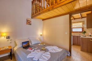 a bedroom with a bed with towels on it at Christinas lofts in Ágios Matthaíos