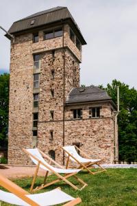 two lounge chairs in front of a brick building at Hallgarter Zange in Oestrich-Winkel
