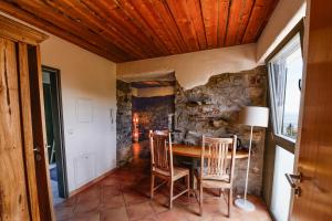 a dining room with a stone wall and a table and chairs at Hallgarter Zange in Oestrich-Winkel