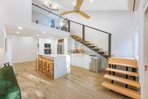 a kitchen with a spiral staircase in a house at On the Brook - Private 2 bed + loft and pool in Brisbane