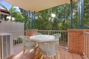 a white table and chairs on a balcony at On the Brook - Private 2 bed + loft and pool in Brisbane