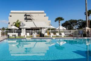 a large swimming pool in front of a hotel at Palazzo Lakeside Hotel in Kissimmee