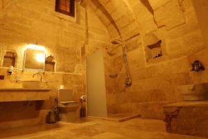 a bathroom with a shower and a toilet and a sink at Zanta Suite Hotel in Urgup