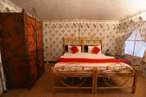 a bedroom with a bed in a room at Jawai Nature Stay - Leopard Safari Camp Jawai Bandh in Bīsalpur