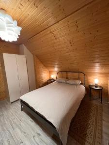 a bedroom with a bed in a wooden ceiling at Domki Skandynawskie Kopalino in Kopalino
