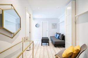 salon z kanapą i lustrem w obiekcie Acogedor estudio en Arturo Soria MD-Anderson E2 w Madrycie