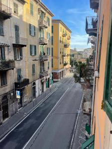 an empty street in a city with buildings at Platform in La Spezia