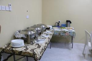 a table with plates and pots and pans on it at Jabel shams stars house in Al Ḩamrāʼ