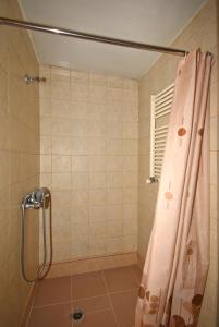 a bathroom with a shower with a pink shower curtain at Abovyan Street 16, Apartment No 24 in Yerevan