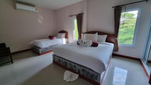 Postel nebo postele na pokoji v ubytování PawPaw Resort