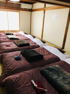 a row of beds sitting in a room at Utatei Sou in Takayama