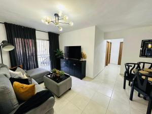 a living room with a couch and a table at Beautiful Condo in La Romana with pool near Caleta Beach in La Romana