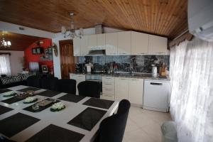 a kitchen and dining room with a table and chairs at VILLA Dori Ani in Tirana