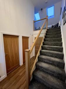a staircase in a home with a stair case at The Hideaway Southport in Southport