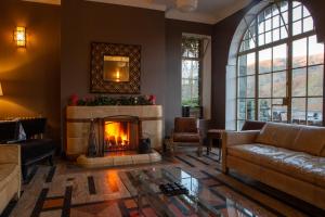 a living room with a couch and a fireplace at Haweswater Hotel in Bampton