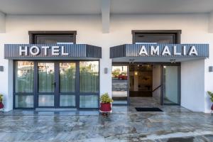 a hotel entrance with a sign that reads hotel amalia at Amalia Hotel in Skopelos Town