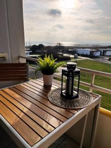 a table on a balcony with a view of the water at Quartier Südstrand - Ferienwohnung mit Meerblick in Fehmarn