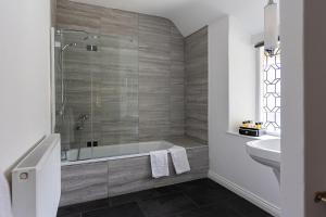 a bathroom with a tub and a sink at The Royal Oak Exmoor in Winsford