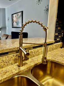 a kitchen sink with a faucet on a counter at Luxury Townhome Jacksonville, NC in Jacksonville