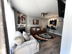a living room with a couch and a fireplace at Luxury Townhome Jacksonville, NC in Jacksonville