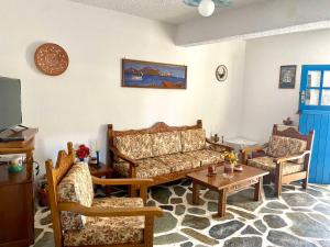 a living room with a couch and two chairs and a table at Gaia home in Prodromos Paros