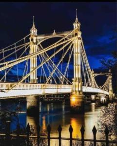 a large bridge over the water at night at Central London New 2 bedroom flat Riverview Balcony in London