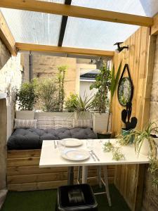 an outdoor dining area with a table and a bench at Le 7 in Caen