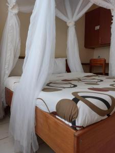 Postel nebo postele na pokoji v ubytování Roza Guest House