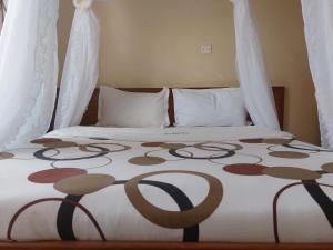 Postel nebo postele na pokoji v ubytování Roza Guest House