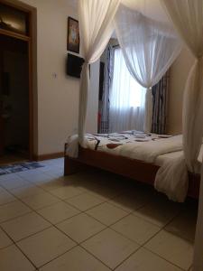 Postel nebo postele na pokoji v ubytování Roza Guest House