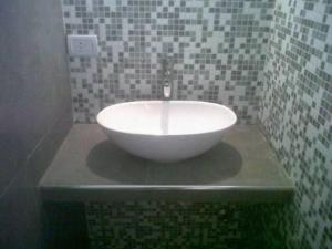 a bathroom with a white bowl sink on a counter at Arenas 497 in Pinamar