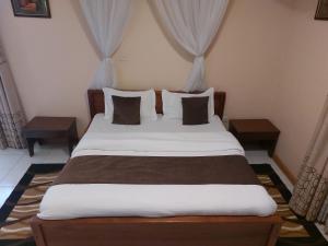 Postel nebo postele na pokoji v ubytování Roza Guest House
