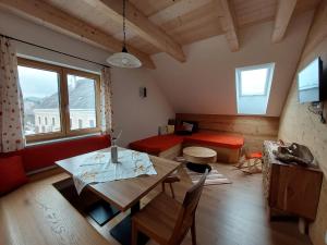 a living room with a table and a couch at Seyerlehnerhof in Maria Neustift