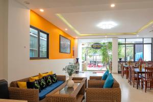 a living room with couches and a dining room at HOIANIAN CENTRAL VILLA in Hoi An