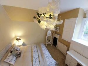 a bedroom with a bed and a chandelier at JESMOND House B&B room 4 in Hull +23 photos