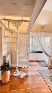 a room with a spiral staircase in the middle of a room at Borgo San Jacopo Penthouse by 360Rentals in Florence