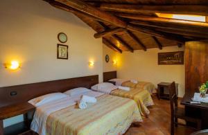 three beds in a room with wooden ceilings at Villa Casina dell'Etna in Ragalna
