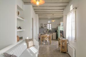 a living room with a couch and a kitchen at Apopsis Tinos View in Triandáros +36 photos