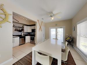 a kitchen and dining room with a white table at La Favorita in Navarre