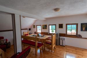 a living room with a wooden table and chairs at Spectacular LakeView House in Žabljak