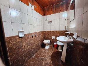 a bathroom with a toilet and a sink at Hotel Los Ángeles in San Clemente del Tuyú