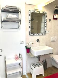 a bathroom with a sink and a mirror at Casa Carolina Ground Floor Apartment 2-4 sleeps in Bellagio