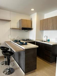 a kitchen with a sink and a counter top at Apartamento de lujo Manizales in Manizales