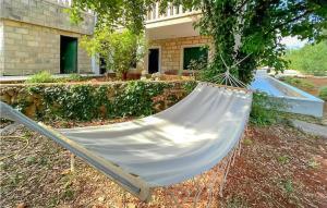 a hammock hanging from a tree in a yard at Stunning Apartment In Zrnovo With Wifi in Žrnovo